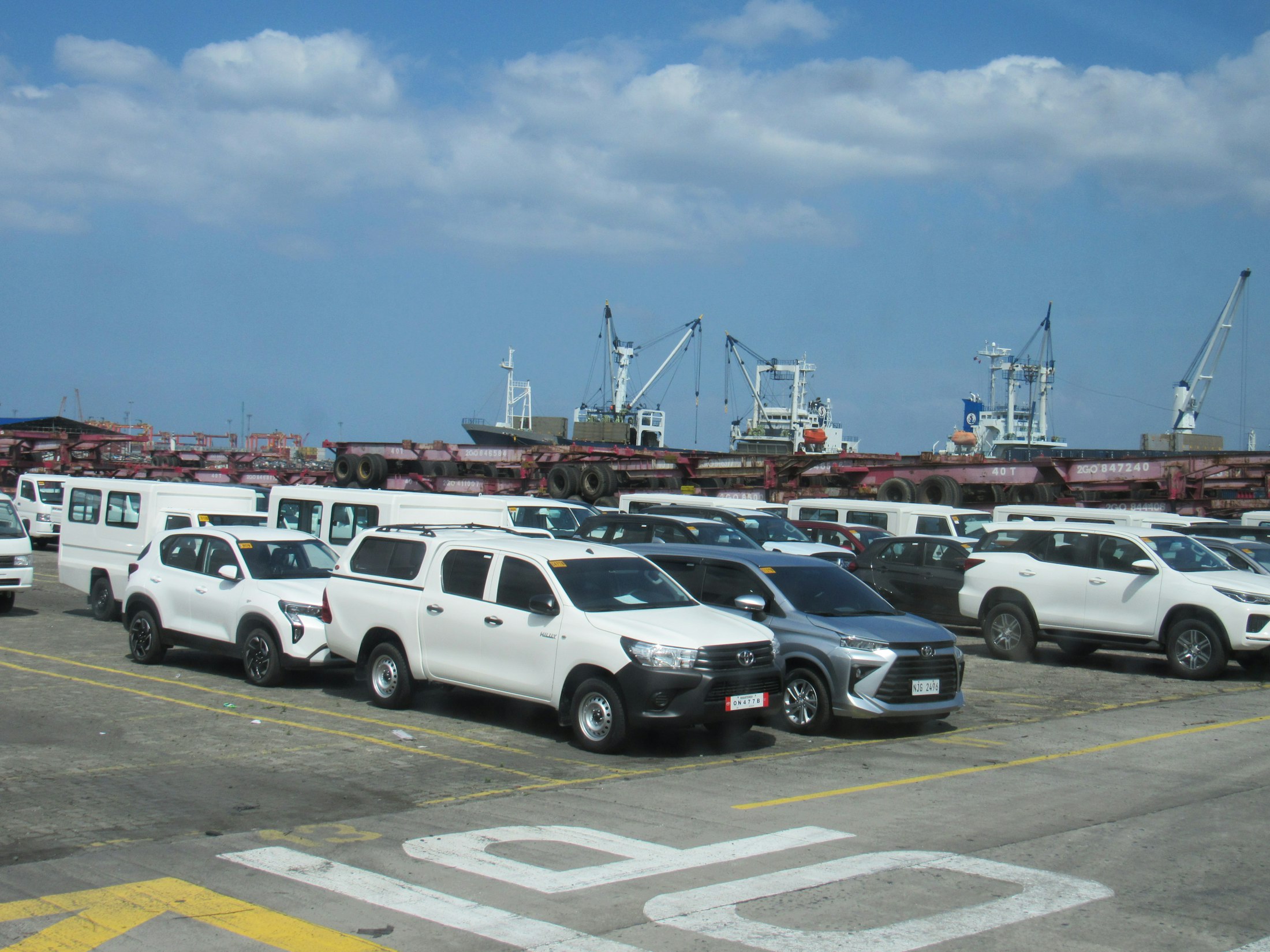Vehicles staged at a shipping port awaiting export